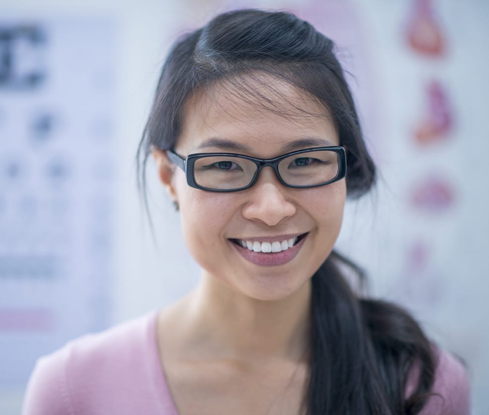 Young woman wearing glasses smiling at the eye doctors office
