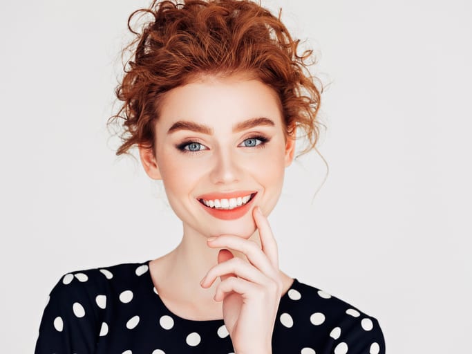 woman smiling in polkadot shirt 