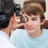 Optometrist performing Dilated Retinal Exam