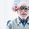 Portrait of a happy mature male patient undergoing vision check with special ophthalmic glasses