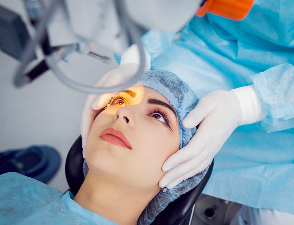 woman in a surgical suite receiving YAG laser treatment on her right eye