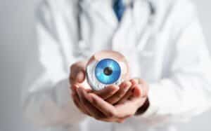 Doctor holds a replica of an eyeball with a cornea