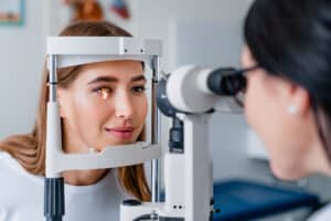 Eye doctor examining a woman’s eyes.