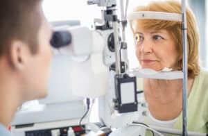 Woman having an eye exam with an optometrist before cataract surgery.